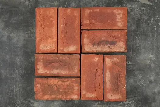 Eight Romsey Antique Clay Paver bricks arranged in display, view from above shows colour and texture against dark background.