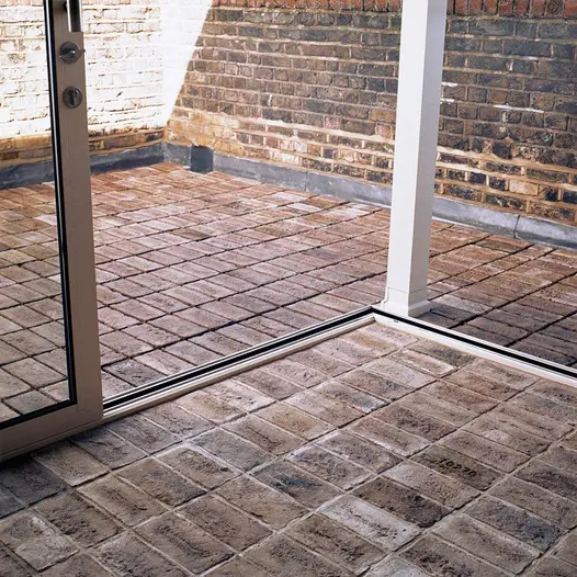 Close view from outbuilding showing off the vast texture and colour variation of london mixture clay pavers.