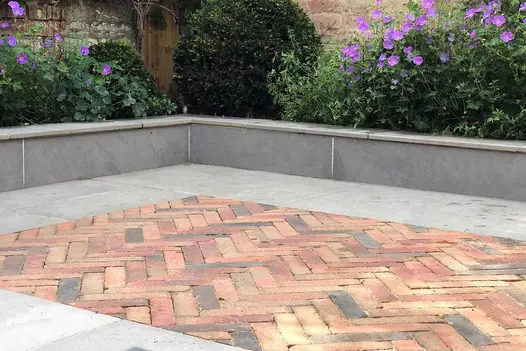 Close-up of Seville Clay Pavers laid in a herringbone pattern, highlighting their texture and design.