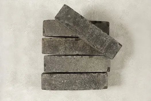 4 Silver Grey Multi brick pavers on edge, showing sanded face, with 5th paver laid at angle on top. Free UK delivery available.