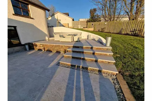 Steps leading to a house from a patio, made of Silver Grey Porcelain, with 3 40mm Downstand Steps heading to dining area.