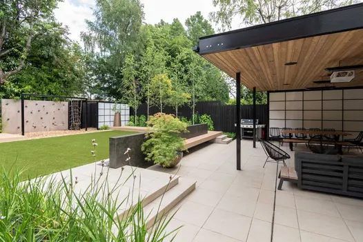 Japanese-influenced garden with Slab Khaki patio and 5mm chamfer steps, lawn and beds. Built by Brockstone. Design by Robert Hughes.