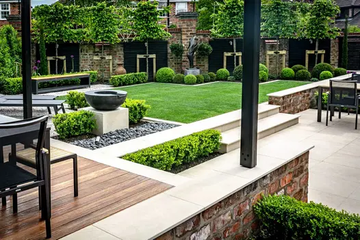 Single step of chamfered Slab Khaki Pool Coping rises to patio doors from matching slabs laid stack bond. Design by Robert Hughes.