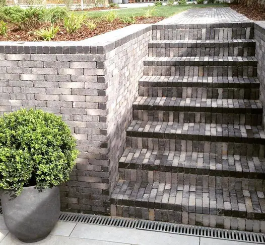 Planter sits next to 6 steps rising between flank walls of Silver Grey Multi Clay Pavers to matching path. Design by Andy Stedman.