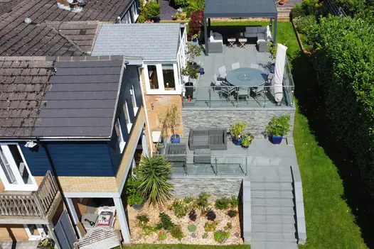 An overhead view of the stylish Trendy Black Porcelain paving, steps and coping, used on a multi-level and impressive patio.