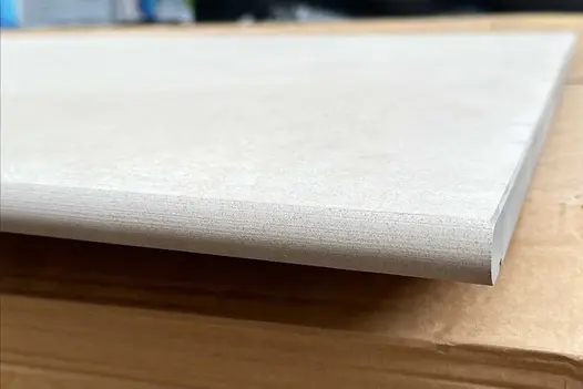 Side profile of one Venetian Beige 20mm moulded bullnose step. Available off the shelf and with free UK delivery.