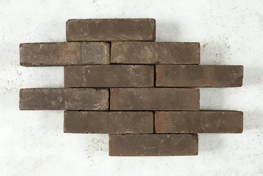 10 Verona clay pavers laid in pattern against a light background, showing bricks’ tones of browns and beige.
