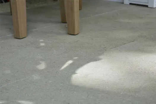 Natural light over Vicenza Sand Flamed Limestone, showing pale tonal shifts and sawn edges in outdoor use.