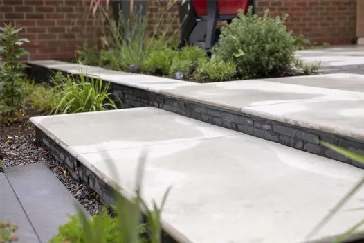 Platinum grey porcelain planks seen on the first level leading to steps using cladding and light coloured porcelain.