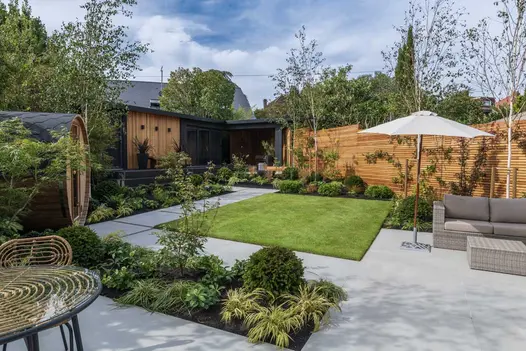 Aerial view of the Yard 1200x1200 Porcelain paving, serving as stepping stones between an outdoor sauna and a remarkable outhouse.